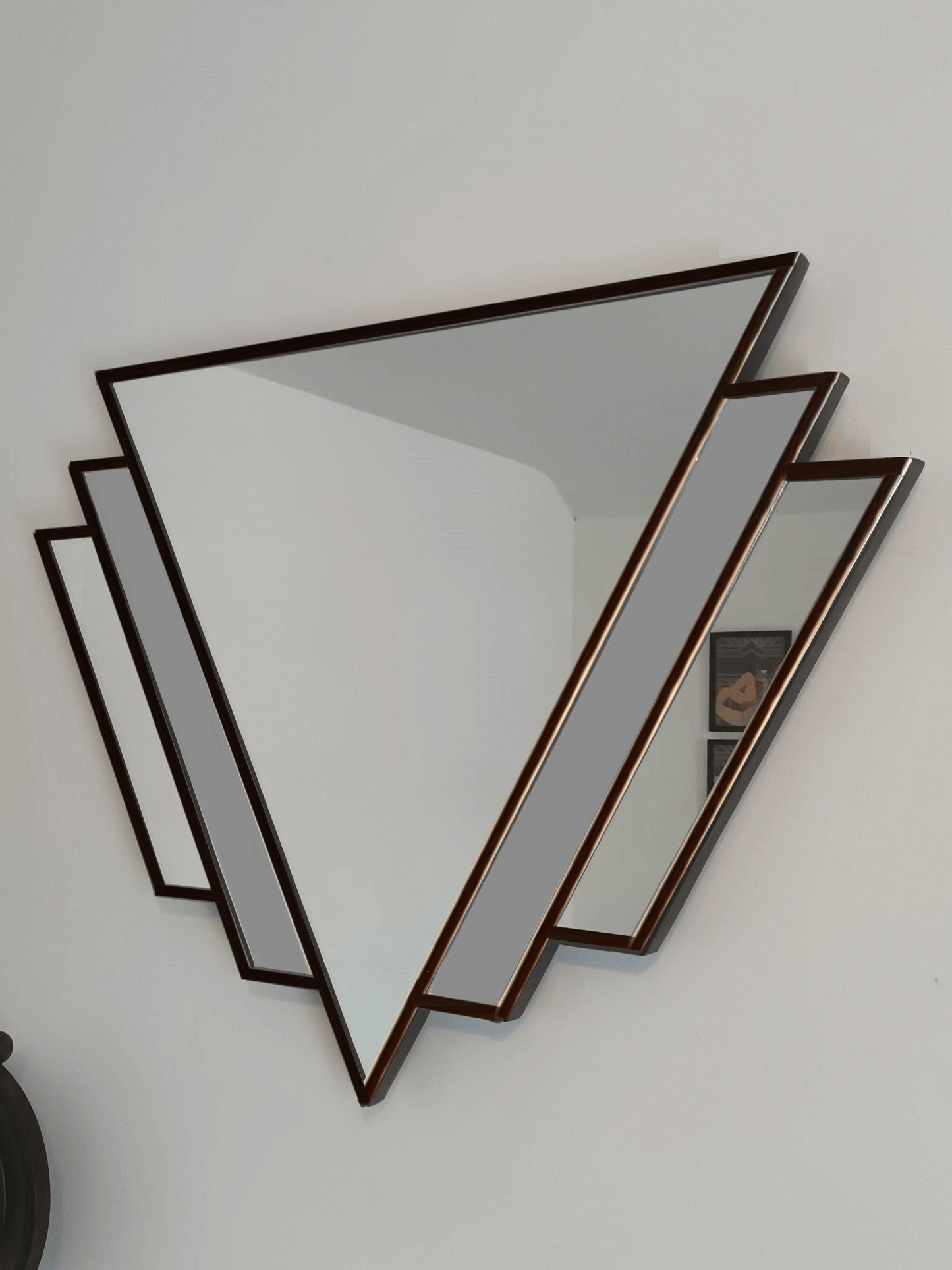 Art deco mirror with grey tinted glass and finished in black trim