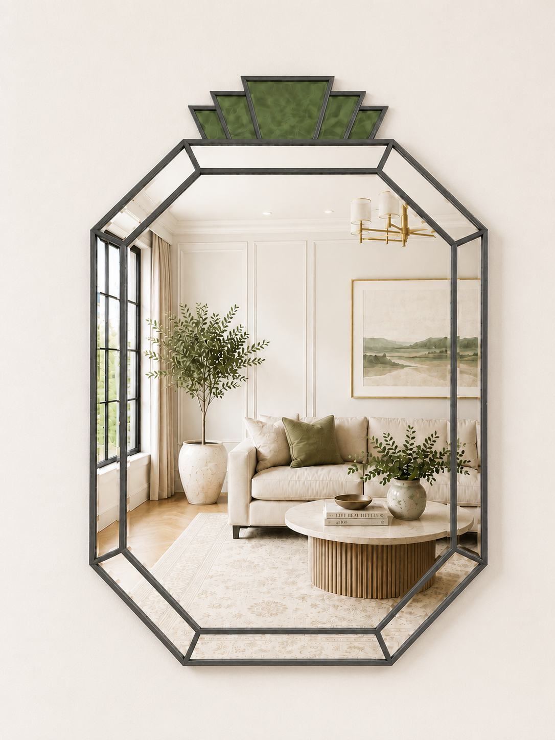 An octagonal wall mirror with a black metal frame and a green geometric crown, shown mounted on a beige wall. The mirror reflects a styled living room interior with a sofa, coffee table, and plants.