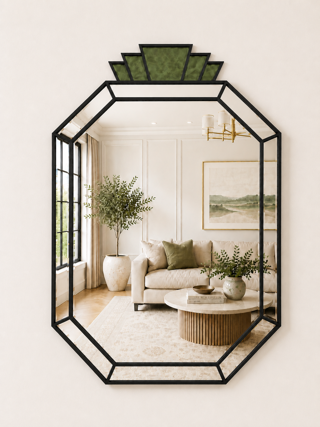 An octagonal wall mirror with a black metal frame and a green geometric crown, shown mounted on a cream wall. The mirror reflects a styled living room interior with a sofa, coffee table, and plants.
