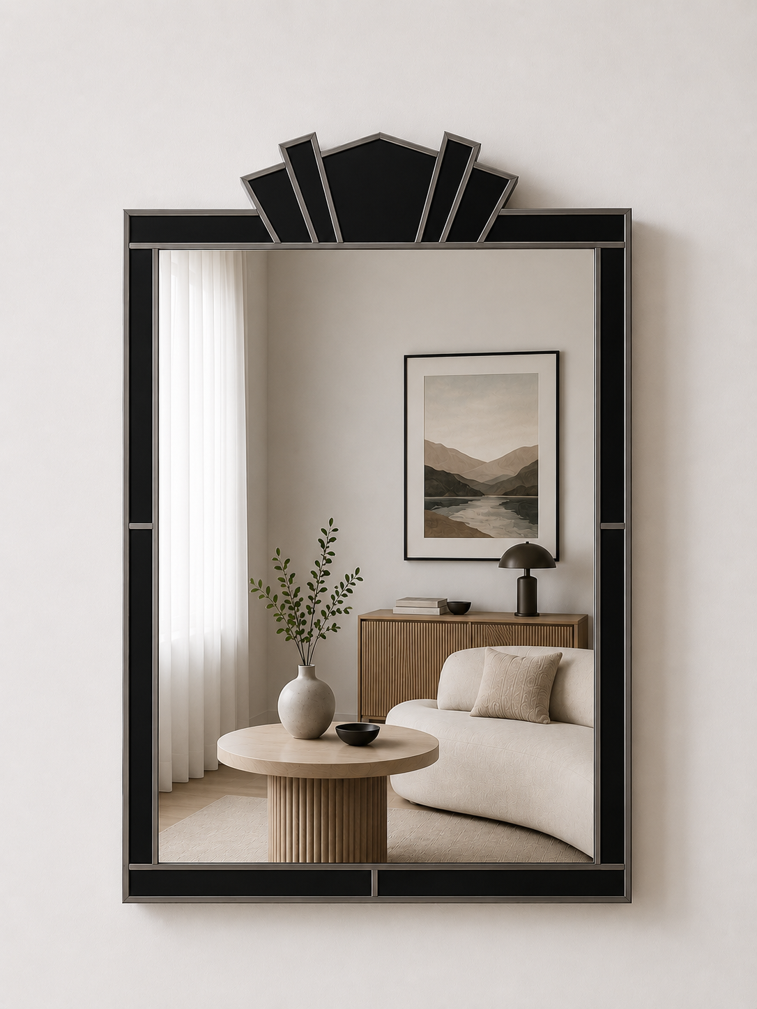 Decorative mirror with a black frame reflecting a living room with a sofa and side table.