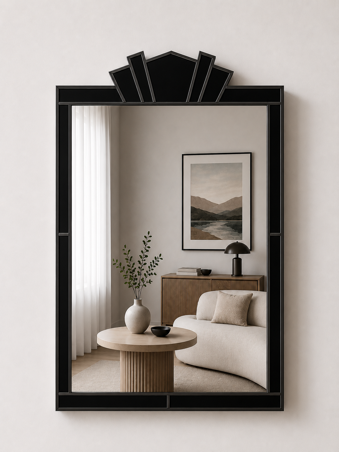 Decorative mirror with a black frame reflecting a living room with a sofa and table.