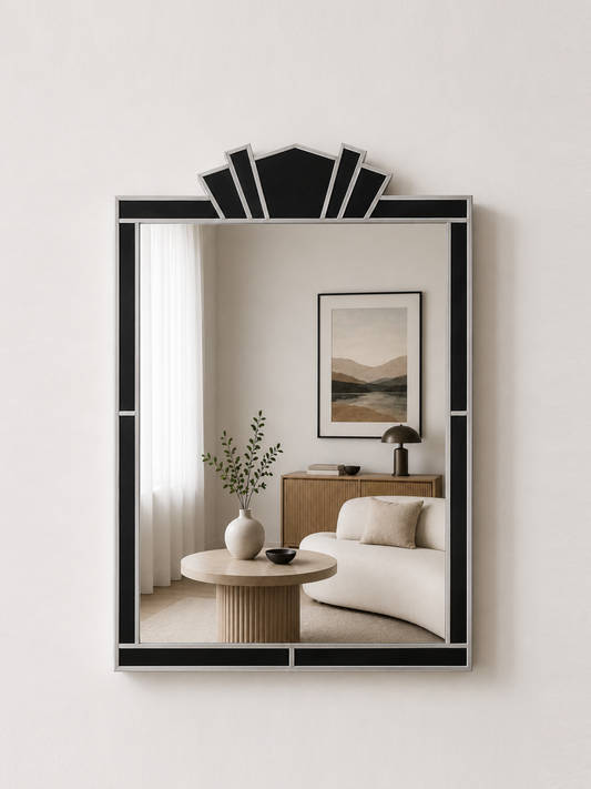 Decorative mirror with black frame in a room with a sofa and table.