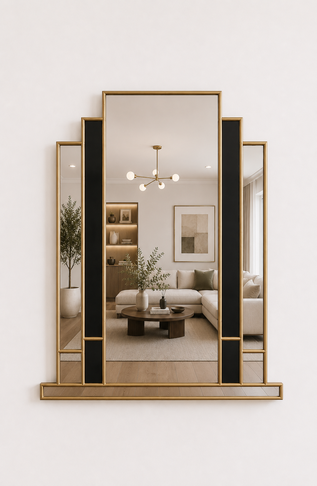 A large decorative wall mirror with a geometric gold frame and black vertical accents, mounted on a white wall. The mirror reflects a modern living room interior with a sofa, coffee table, and plant.