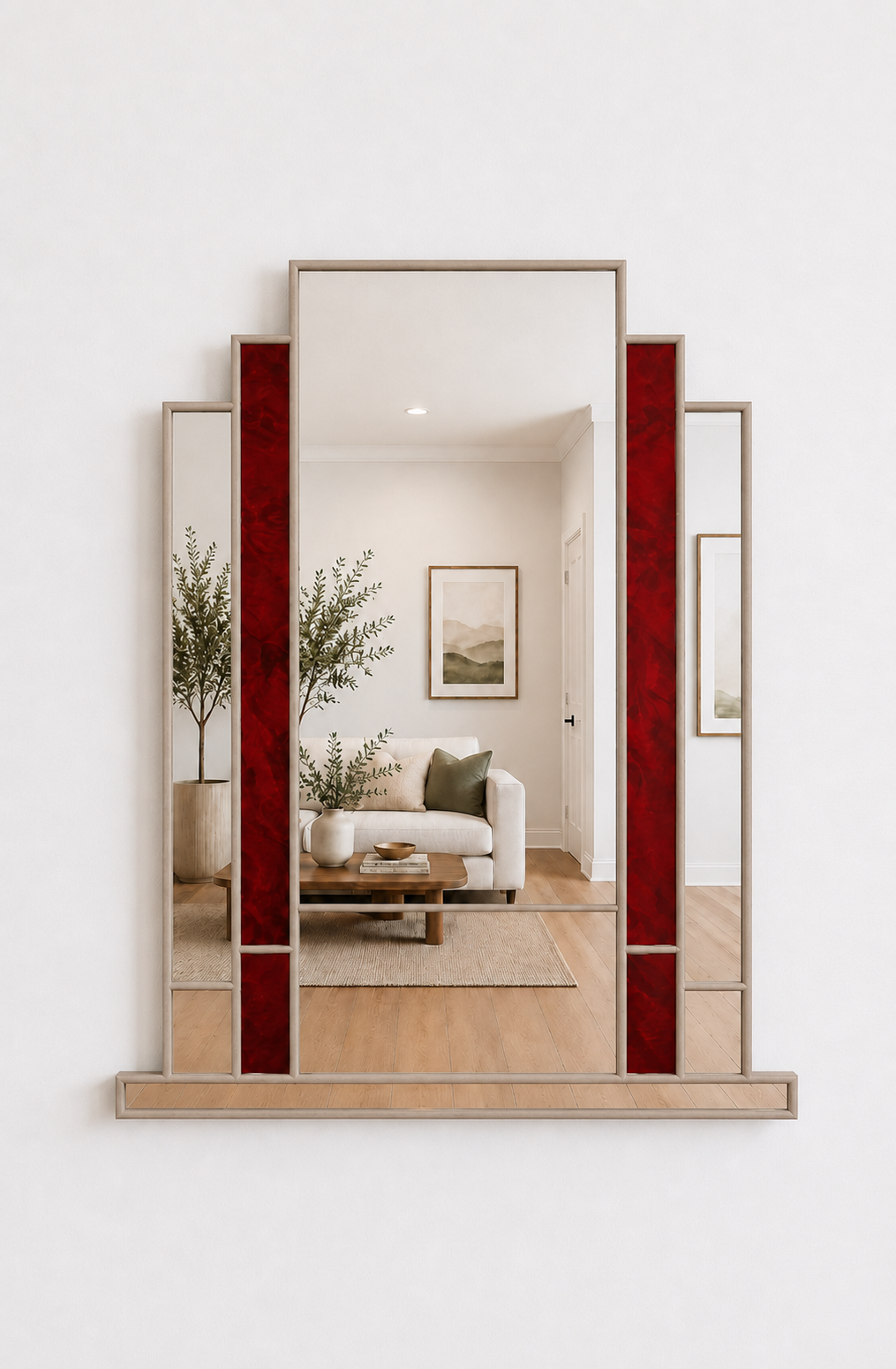A large decorative wall mirror with a geometric frame, featuring vertical red textured side panels and a light wood base, mounted on a white wall.