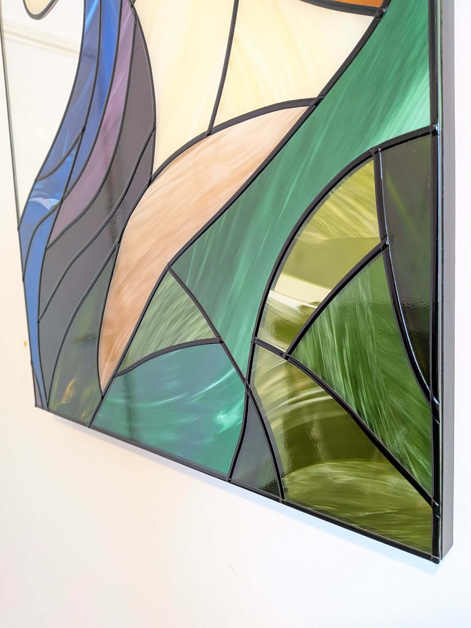 Modern stained glass style wall art featuring a colourful abstract portrait of a woman in profile. This vertical framed artwork showcases bold geometric shapes in rich blue, purple, green, and warm amber tones, with striking red lips and a green eye. The contemporary cubist-inspired design adds elegance and sophistication to living rooms, bedrooms, offices, or gallery walls. A vibrant statement piece perfect for modern home décor, art collectors, and unique gift ideas.