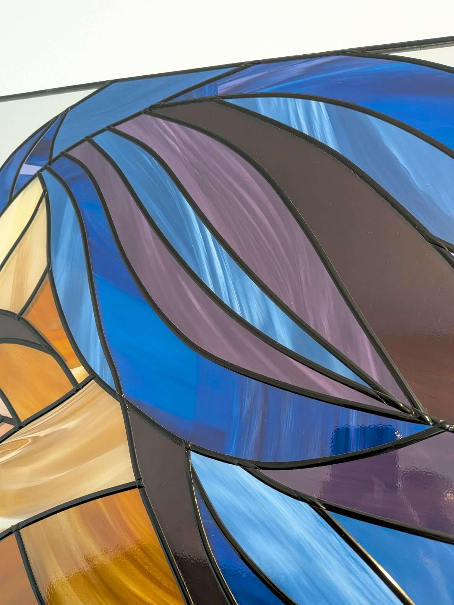 Modern stained glass style wall art featuring a colourful abstract portrait of a woman in profile. This vertical framed artwork showcases bold geometric shapes in rich blue, purple, green, and warm amber tones, with striking red lips and a green eye. The contemporary cubist-inspired design adds elegance and sophistication to living rooms, bedrooms, offices, or gallery walls. A vibrant statement piece perfect for modern home décor, art collectors, and unique gift ideas.
