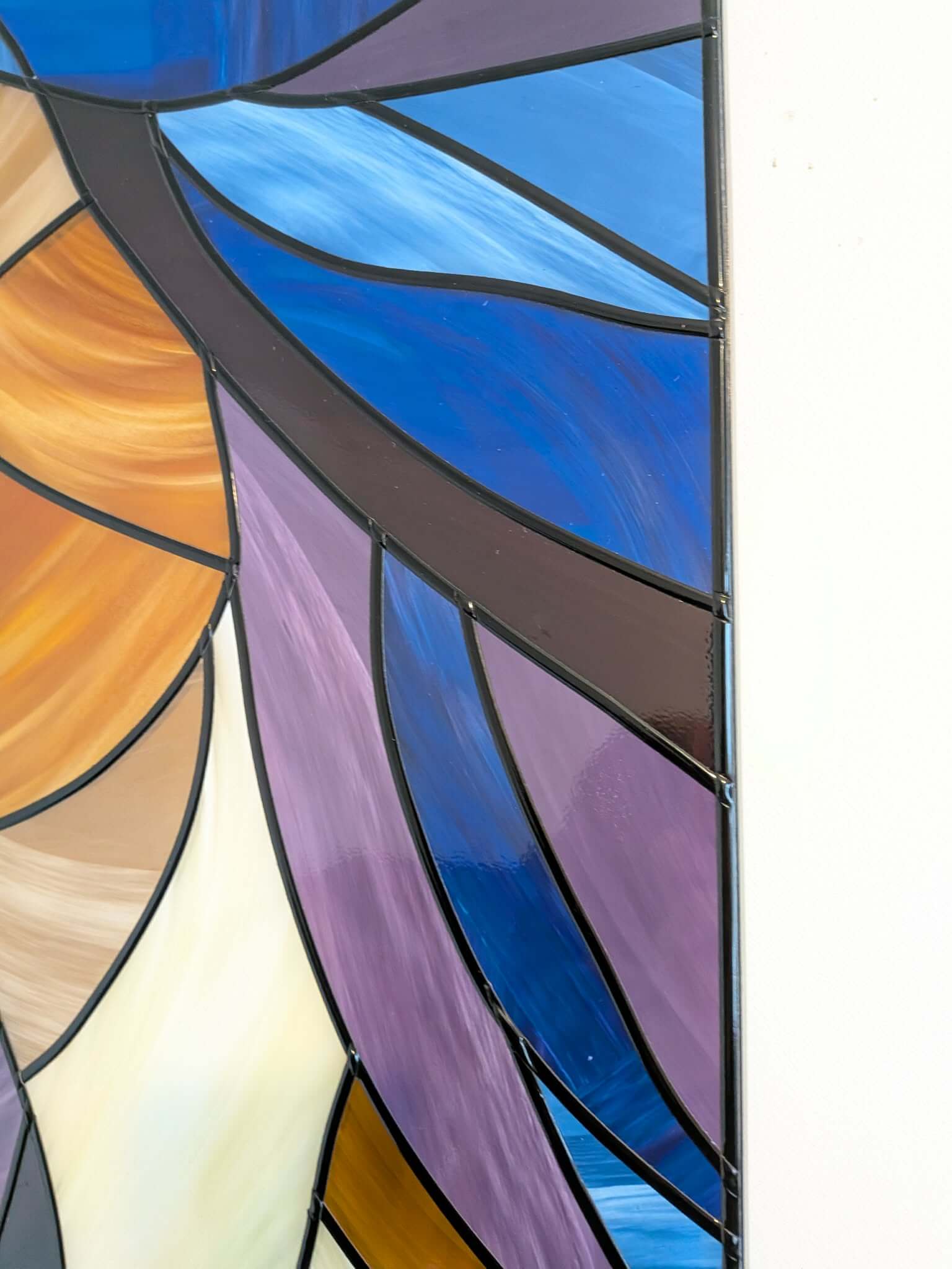 Modern stained glass style wall art featuring a colourful abstract portrait of a woman in profile. This vertical framed artwork showcases bold geometric shapes in rich blue, purple, green, and warm amber tones, with striking red lips and a green eye. The contemporary cubist-inspired design adds elegance and sophistication to living rooms, bedrooms, offices, or gallery walls. A vibrant statement piece perfect for modern home décor, art collectors, and unique gift ideas.